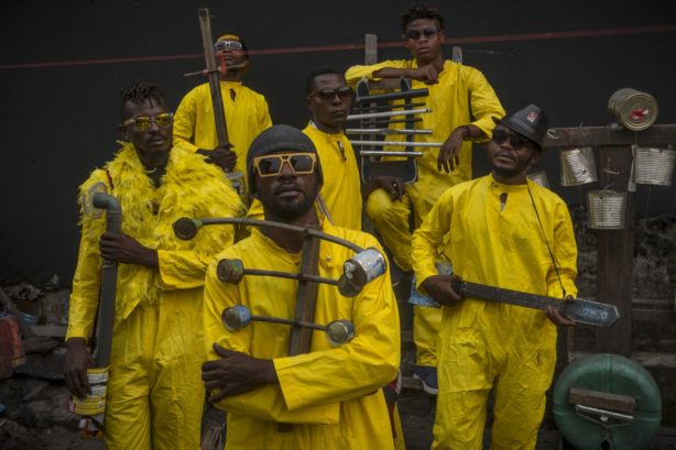 a group of men in yellow jumpsuits 