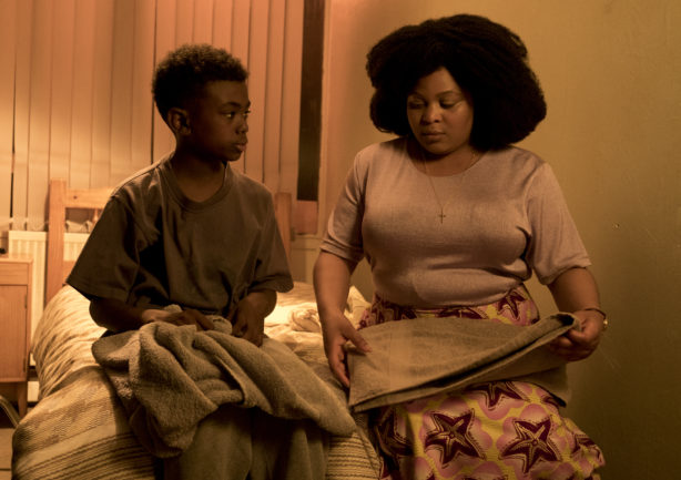 A young Femi (Tai Golding) and his mother (Gbemisola Ikumelo) have a conversation in their home.