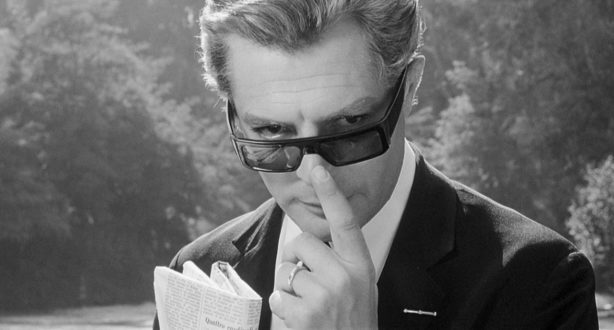 A man looking down out of his sunglasses