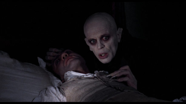 Vampire and a man in bed.