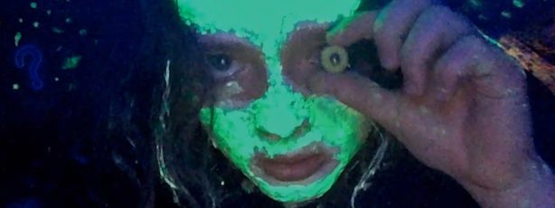 A scary grainy-green face stares us down with the help of a dolls eye.